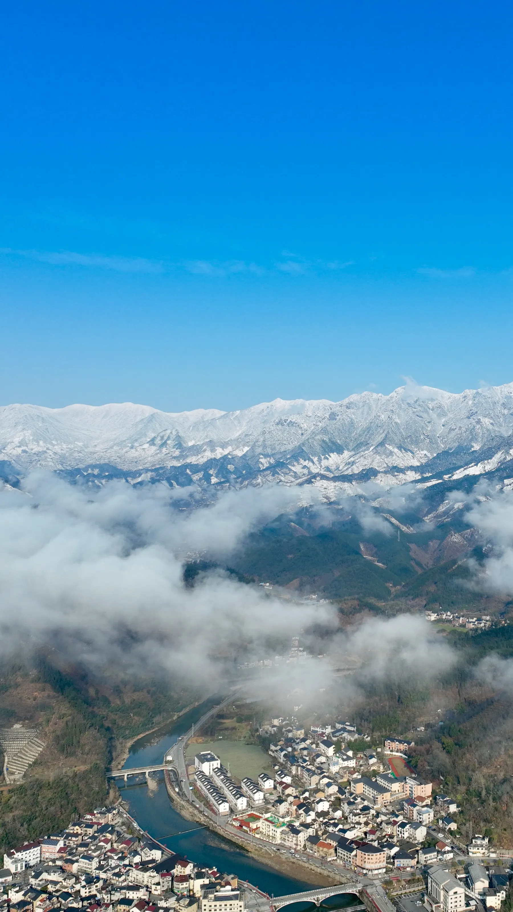 Snow peaks above a sea of clouds