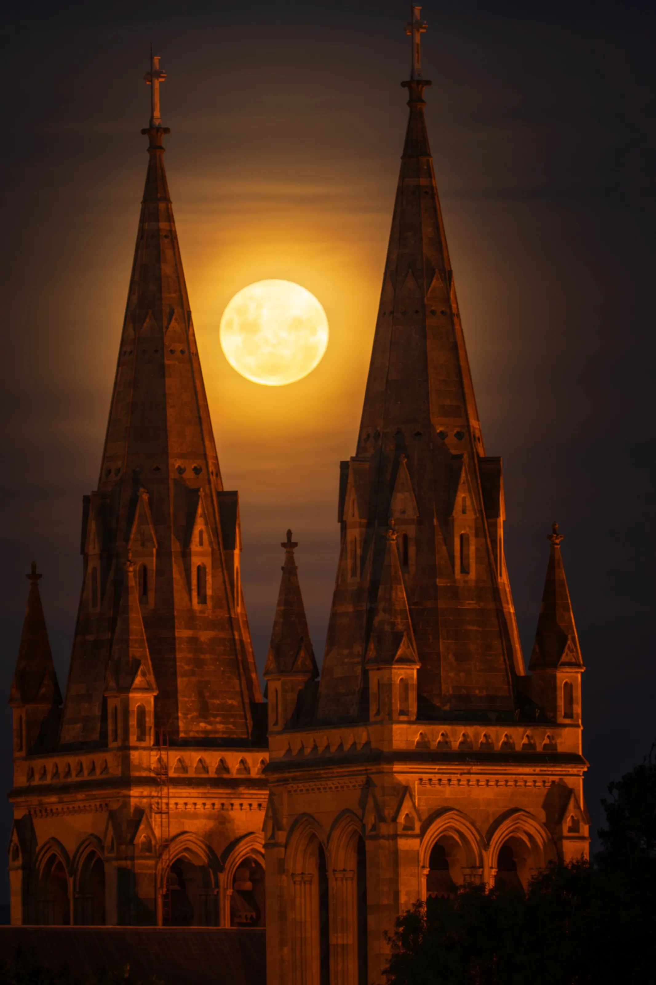 Full moon rising between twin gothic spires