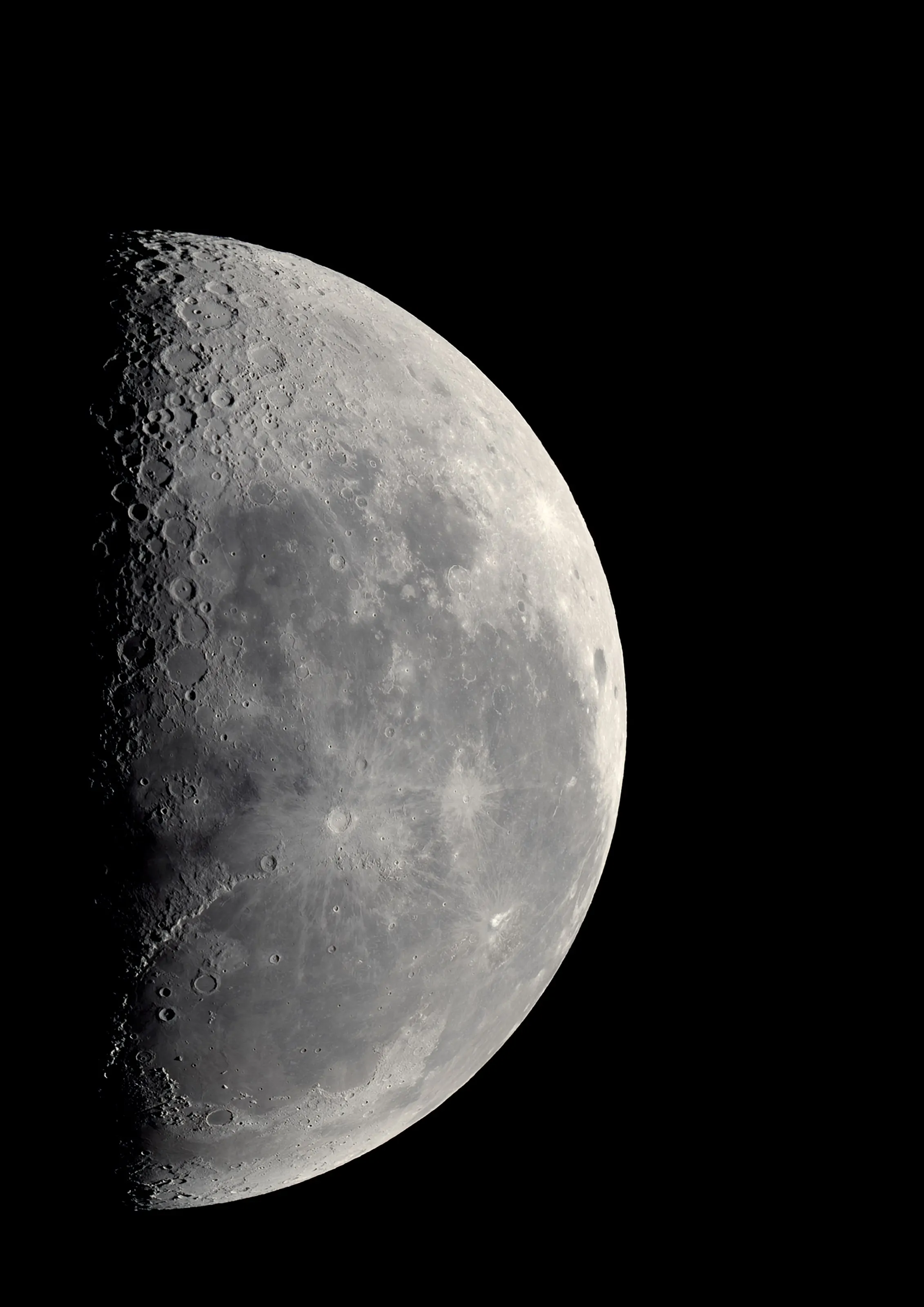 A waning moon in close-up, craters sharp along the terminator